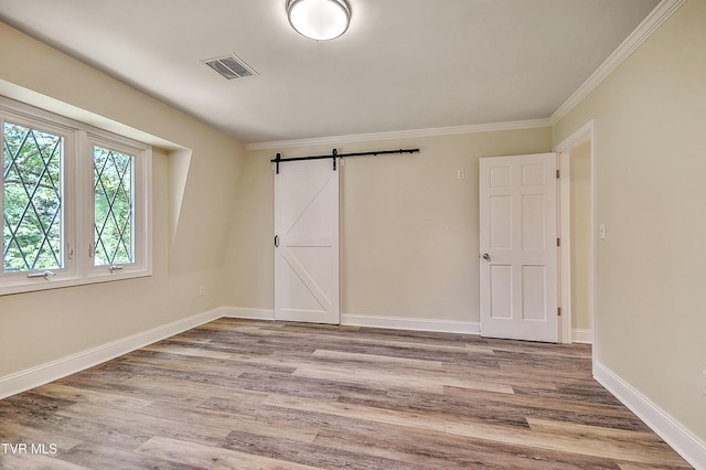 505 Red Oak Ln, Kingsport, TN 37663 - unfurnished bedroom with a barn door, wood finished floors, and crown molding