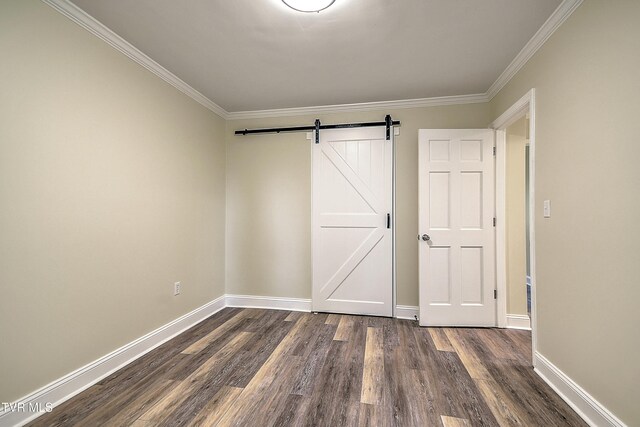 505 Red Oak Ln, Kingsport, TN 37663 - unfurnished bedroom with a barn door, dark wood-style floors, and crown molding