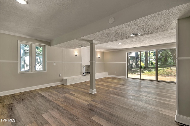 505 Red Oak Ln, Kingsport, TN 37663 - basement with a textured ceiling, hardwood / wood-style floors, healthy amount of natural light, and crown molding