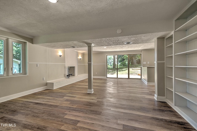 505 Red Oak Ln, Kingsport, TN 37663 - unfurnished living room with a textured ceiling, ornate columns, and dark wood-style floors