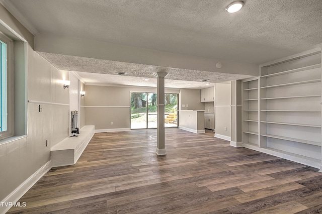 505 Red Oak Ln, Kingsport, TN 37663 - unfurnished living room with a textured ceiling, dark wood-style flooring, built in features, and ornate columns
