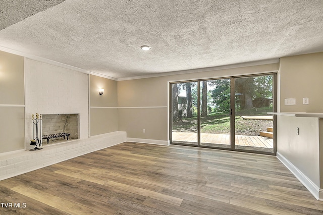 505 Red Oak Ln, Kingsport, TN 37663 - unfurnished living room featuring hardwood / wood-style flooring, ornamental molding, a fireplace, and a textured ceiling
