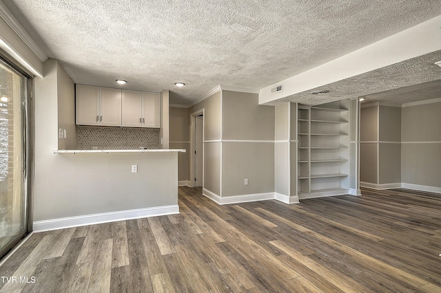 505 Red Oak Ln, Kingsport, TN 37663 - unfurnished living room with a textured ceiling, dark wood-style floors, and ornamental molding