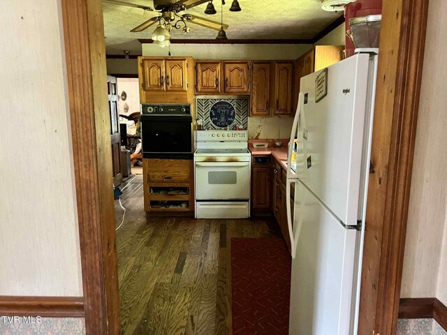 12615 Star Branch Rd, Coeburn, VA 24230 - kitchen featuring white appliances, brown cabinetry, dark wood-style floors, ceiling fan, and light countertops