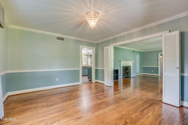 421 High Ridge Rd, Kingsport, TN 37660 - unfurnished living room featuring a chandelier, wood finished floors, baseboards, a fireplace, and crown molding