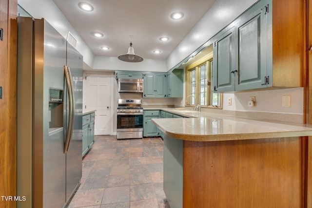 421 High Ridge Rd, Kingsport, TN 37660 - kitchen featuring appliances with stainless steel finishes, a peninsula, light countertops, dark stone finish floors, and a sink