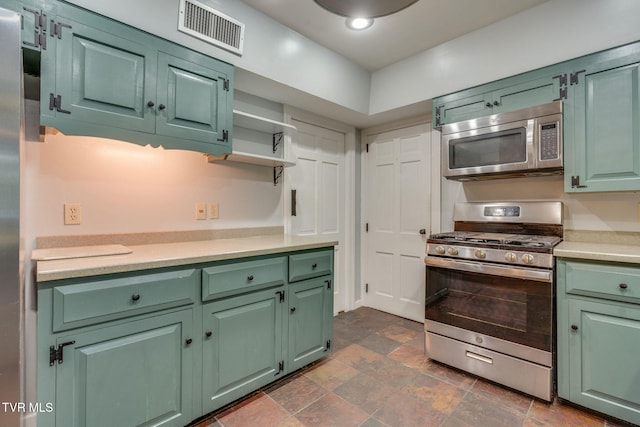 421 High Ridge Rd, Kingsport, TN 37660 - kitchen featuring stainless steel appliances, green cabinetry, light countertops, stone finish flooring, and open shelves