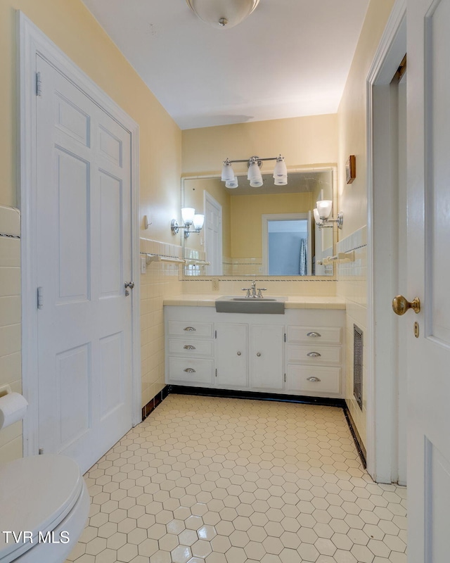 421 High Ridge Rd, Kingsport, TN 37660 - bathroom with vanity, tile walls, toilet, and a wainscoted wall