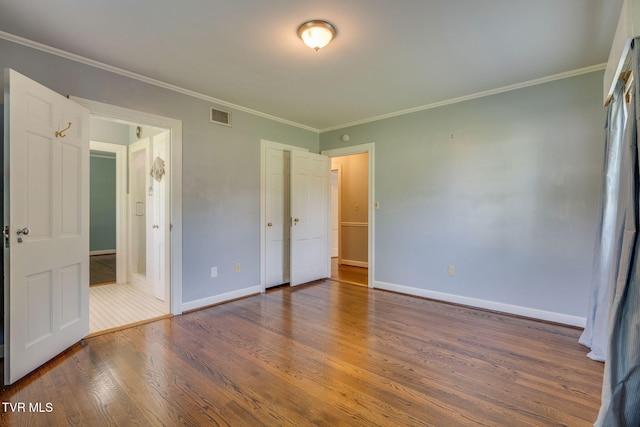 421 High Ridge Rd, Kingsport, TN 37660 - unfurnished bedroom with wood finished floors, baseboards, and crown molding