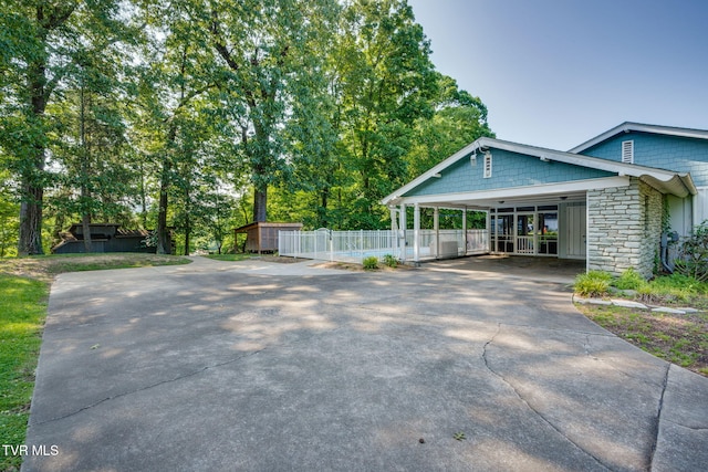 421 High Ridge Rd, Kingsport, TN 37660 - view of side of property with concrete driveway, stone siding, and a carport