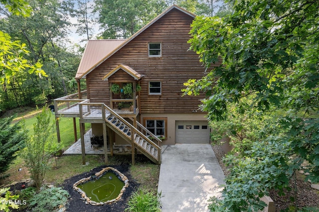 9245 Mendota Rd, Mendota, VA 24270 - view of front of property with an attached garage, driveway, a deck, stairs, and metal roof