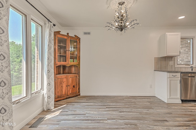 14191 King Mill Pike, Bristol, VA 24202 - unfurnished dining area with a chandelier, healthy amount of natural light, light wood finished floors, ornamental molding, and baseboards