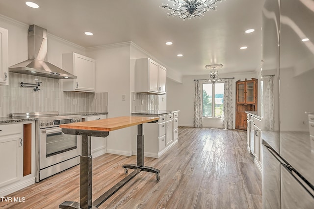 14191 King Mill Pike, Bristol, VA 24202 - kitchen featuring wall chimney range hood, stainless steel electric range oven, butcher block countertops, white cabinets, and backsplash