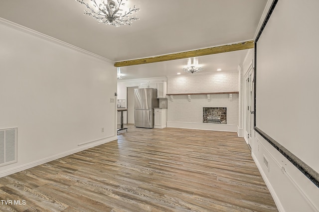 14191 King Mill Pike, Bristol, VA 24202 - unfurnished living room with a chandelier, wood finished floors, ornamental molding, a fireplace, and baseboards