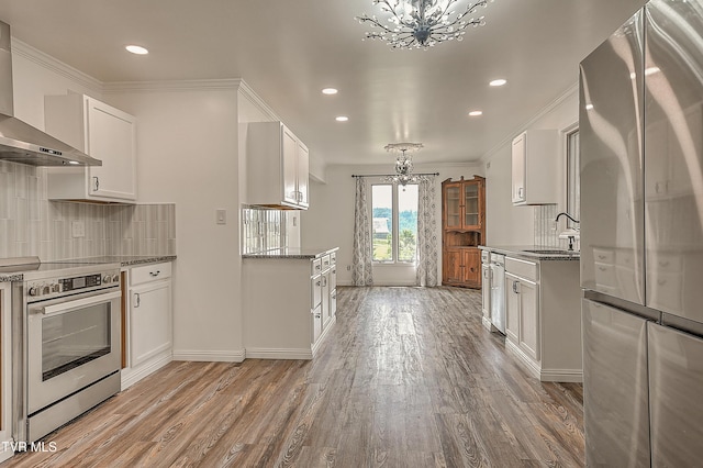14191 King Mill Pike, Bristol, VA 24202 - kitchen with a chandelier, appliances with stainless steel finishes, wall chimney exhaust hood, a sink, and light wood-style floors