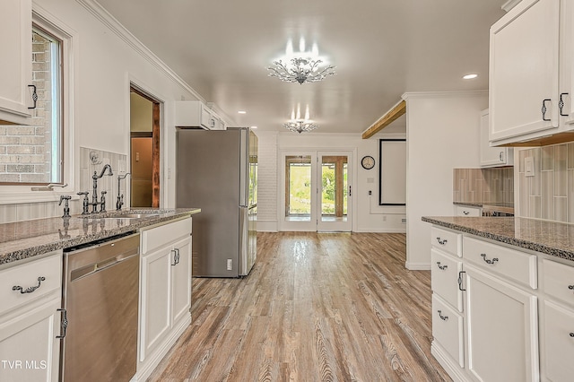 14191 King Mill Pike, Bristol, VA 24202 - kitchen with appliances with stainless steel finishes, crown molding, a sink, white cabinetry, and light wood-style flooring