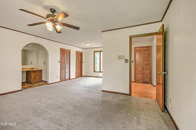 14191 King Mill Pike, Bristol, VA 24202 - empty room with carpet flooring, arched walkways, a ceiling fan, a textured ceiling, and baseboards