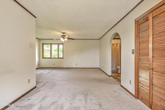 14191 King Mill Pike, Bristol, VA 24202 - empty room with arched walkways, a ceiling fan, light colored carpet, a textured ceiling, and ornamental molding