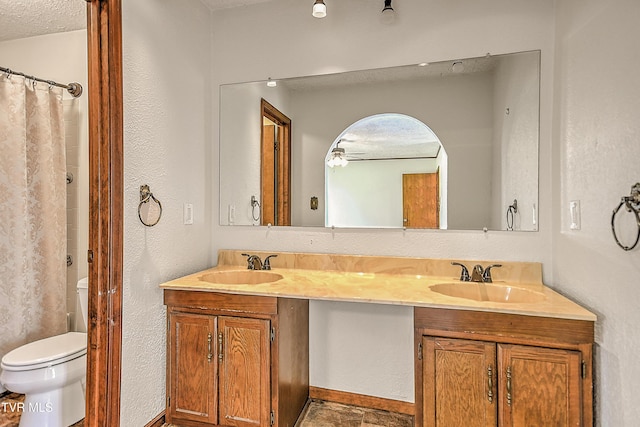 14191 King Mill Pike, Bristol, VA 24202 - bathroom with double vanity, toilet, a textured ceiling, and curtained shower