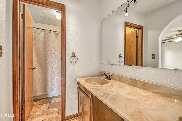 14191 King Mill Pike, Bristol, VA 24202 - bathroom featuring vanity, a textured ceiling, ceiling fan, a textured wall, and curtained shower