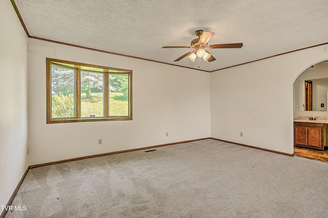 14191 King Mill Pike, Bristol, VA 24202 - spare room with a ceiling fan, light carpet, a textured ceiling, ornamental molding, and arched walkways