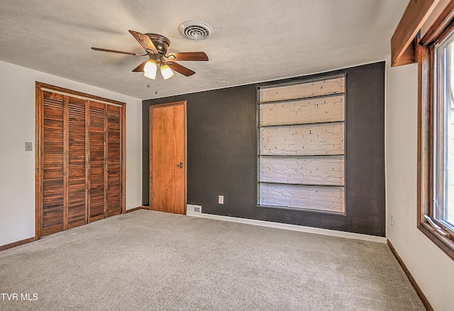 14191 King Mill Pike, Bristol, VA 24202 - unfurnished bedroom featuring carpet, a closet, baseboards, a textured ceiling, and multiple windows