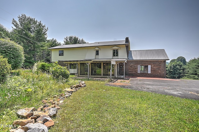 14191 King Mill Pike, Bristol, VA 24202 - rear view of property with a chimney, metal roof, brick siding, and a lawn