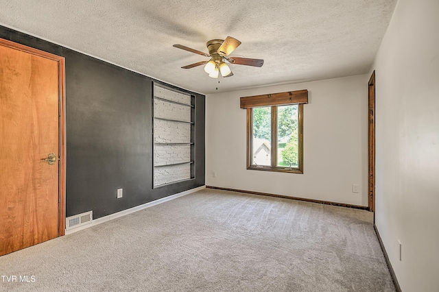 14191 King Mill Pike, Bristol, VA 24202 - spare room with a textured ceiling, light colored carpet, ceiling fan, and baseboards