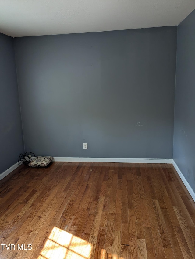 1319 5th St, Bristol, TN 37620 - empty room featuring wood finished floors and baseboards