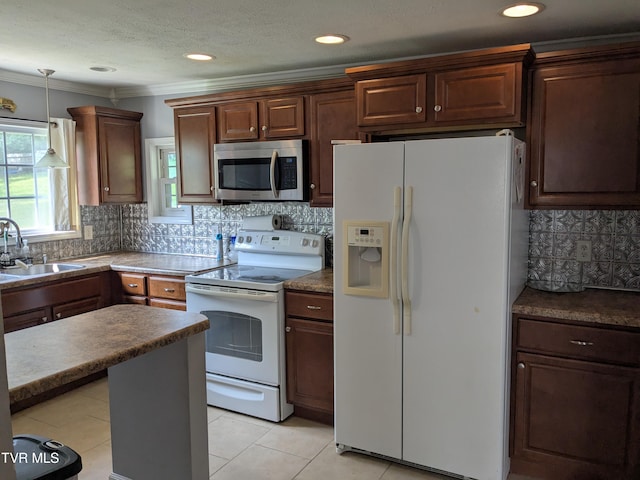 1319 5th St, Bristol, TN 37620 - kitchen featuring white appliances, a sink, hanging light fixtures, decorative backsplash, and light tile patterned floors