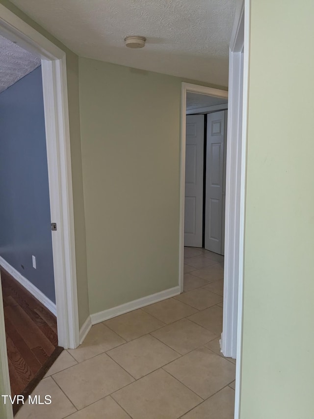 1319 5th St, Bristol, TN 37620 - corridor featuring a textured ceiling, light tile patterned floors, and baseboards
