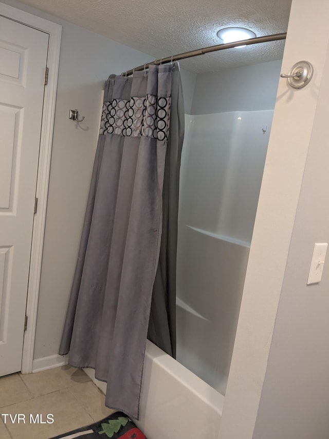 1319 5th St, Bristol, TN 37620 - bathroom with tile patterned flooring, a textured ceiling, and shower / bathtub combination with curtain