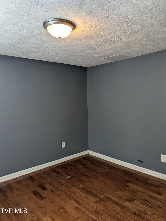 1319 5th St, Bristol, TN 37620 - unfurnished room featuring wood finished floors, a textured ceiling, and baseboards