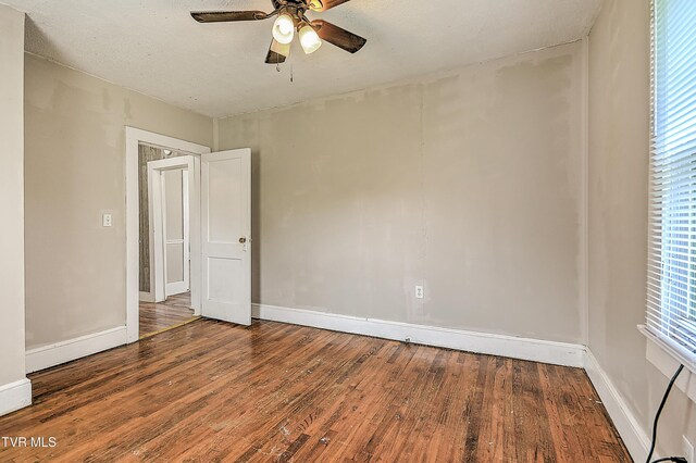 1725 Highland St, Kingsport, TN 37664 - unfurnished room with wood finished floors, ceiling fan, and baseboards