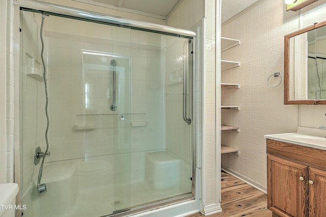 1725 Highland St, Kingsport, TN 37664 - full bath with tile walls, a shower stall, and wood finished floors