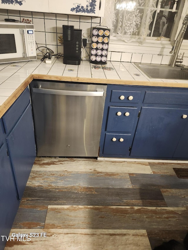127 Banner St, Erwin, TN 37650 - kitchen featuring blue cabinets, dishwasher, white microwave, and tile counters