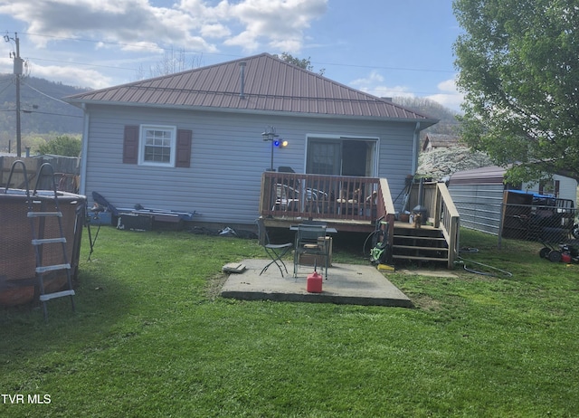 127 Banner St, Erwin, TN 37650 - back of property with a wooden deck, a patio area, and metal roof