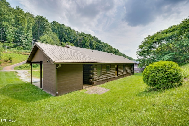 366 Judge Ben Allen Rd, Elizabethton, TN 37643 - rear view of property featuring metal roof, an outbuilding, log siding, and a lawn