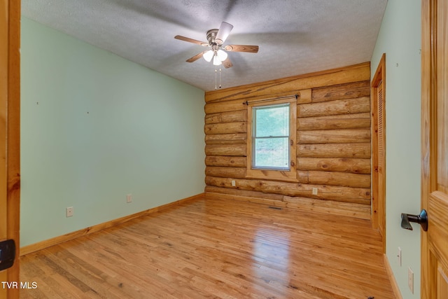 366 Judge Ben Allen Rd, Elizabethton, TN 37643 - unfurnished room featuring rustic walls, a textured ceiling, ceiling fan, light wood-style floors, and baseboards