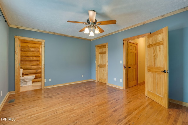 366 Judge Ben Allen Rd, Elizabethton, TN 37643 - unfurnished bedroom featuring wood finished floors, baseboards, log walls, connected bathroom, and ornamental molding