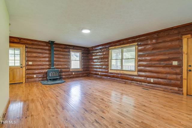 366 Judge Ben Allen Rd, Elizabethton, TN 37643 - unfurnished living room with a wood stove, wood-type flooring, and rustic walls
