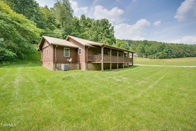 366 Judge Ben Allen Rd, Elizabethton, TN 37643 - rear view of house featuring central air condition unit, a forest view, a lawn, and metal roof