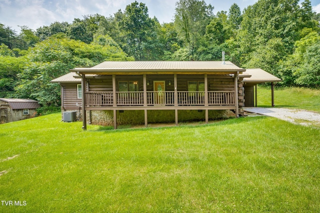 366 Judge Ben Allen Rd, Elizabethton, TN 37643 - log-style house featuring central air condition unit, a front yard, metal roof, and a carport