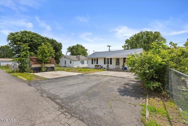 204 E Millpond St, Kingsport, TN 37660 - view of front of house with metal roof, asphalt driveway, a porch, and central AC unit