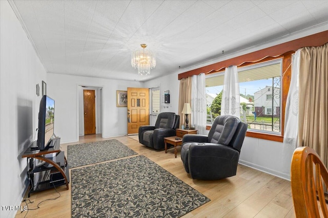 204 E Millpond St, Kingsport, TN 37660 - living room featuring a chandelier, light wood-type flooring, and baseboards