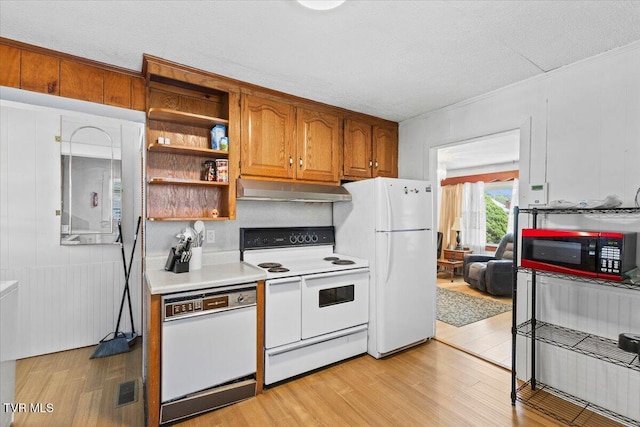 204 E Millpond St, Kingsport, TN 37660 - kitchen with white appliances, under cabinet range hood, light countertops, light wood finished floors, and brown cabinetry