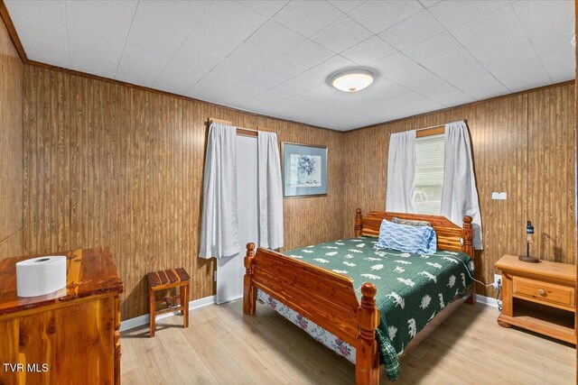 204 E Millpond St, Kingsport, TN 37660 - bedroom with light wood-type flooring, wood walls, and baseboards