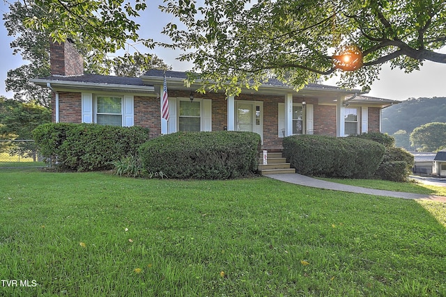 112 Hillview Rd, Kingsport, TN 37664 - view of front facade featuring a front yard, a chimney, brick siding, and a porch