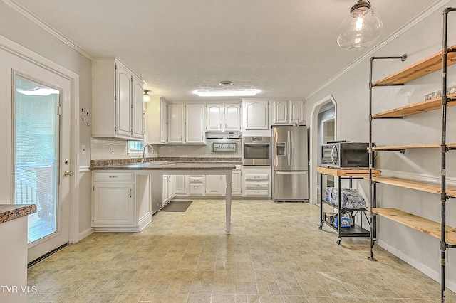 112 Hillview Rd, Kingsport, TN 37664 - kitchen with appliances with stainless steel finishes, dark countertops, white cabinets, ornamental molding, and decorative backsplash