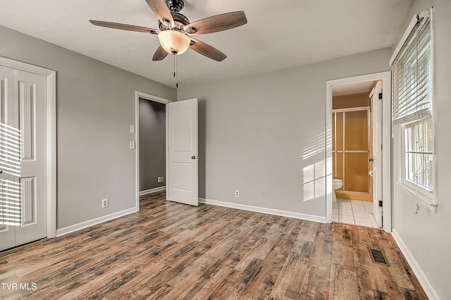 112 Hillview Rd, Kingsport, TN 37664 - unfurnished bedroom featuring wood finished floors, connected bathroom, and ceiling fan